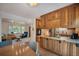 Open concept kitchen with wood cabinets and granite counter tops at 6248 W 75Th, Arvada, CO 80003