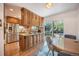 Kitchen with wood cabinets, stainless steel appliances, breakfast bar, and access to backyard patio at 6248 W 75Th, Arvada, CO 80003