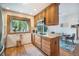 Bright kitchen featuring granite counters, wood cabinets, view of backyard and breakfast nook at 6248 W 75Th, Arvada, CO 80003