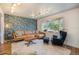 Stylish living room with patterned wallpaper, comfortable furniture, large bay window, and elegant decor at 6248 W 75Th, Arvada, CO 80003