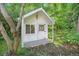 Charming backyard playhouse nestled among mature trees and greenery at 6248 W 75Th, Arvada, CO 80003