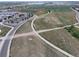 Aerial view showing school buildings with solar panels and athletic fields in a planned community at 5434 N Xenia St, Denver, CO 80238
