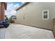 Side view of the home highlighting the spacious backyard, accented by a concrete patio and wood fence at 5434 N Xenia St, Denver, CO 80238