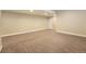 Unfurnished basement space with neutral walls, carpeted flooring, and a white door at 5434 N Xenia St, Denver, CO 80238