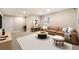 Stylish basement living area with a comfortable brown couch, a rug, and modern decor at 5434 N Xenia St, Denver, CO 80238