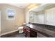 Well-lit bathroom with dark wood vanity, granite countertop, and a shower with clear glass doors at 5434 N Xenia St, Denver, CO 80238