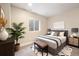 A sunlit bedroom boasts a comfortable bed with a patterned rug, with stylish decor at 5434 N Xenia St, Denver, CO 80238