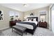 Comfortable bedroom with a queen bed, matching nightstands, and stylish black-and-white geometric rug at 5434 N Xenia St, Denver, CO 80238