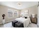 Bright bedroom featuring large windows, a neutral color scheme, and matching bedside tables at 5434 N Xenia St, Denver, CO 80238