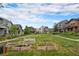 Beautiful community garden with raised beds, surrounded by colorful houses under a bright blue sky at 5434 N Xenia St, Denver, CO 80238