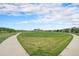 Expansive green space in the community with walking paths and residential homes in the background at 5434 N Xenia St, Denver, CO 80238