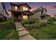 Charming two-story home with inviting front porch, steps, and well-maintained landscaping at 5434 N Xenia St, Denver, CO 80238
