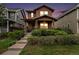 Charming two-story home featuring a welcoming front porch, landscaped yard, and a beautiful sunset backdrop at 5434 N Xenia St, Denver, CO 80238