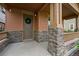 Close-up of a charming front porch with stone accents, a decorative wreath, and the house number at 5434 N Xenia St, Denver, CO 80238