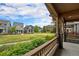 View from porch showing lush landscaping and neighboring homes with a central green space at 5434 N Xenia St, Denver, CO 80238