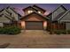 Two-story home featuring a single-car garage with natural wood trim and matching wooden fence at 5434 N Xenia St, Denver, CO 80238