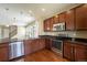 Kitchen boasts stainless steel appliances, granite countertops, dark cabinets and hardwood flooring at 5434 N Xenia St, Denver, CO 80238