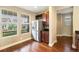 Eat-in kitchen features stainless steel refrigerator, dark cabinetry, and backyard views from the windows at 5434 N Xenia St, Denver, CO 80238