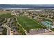 An aerial view showcasing the community's green spaces, baseball field, tennis courts, and neighborhood layout at 2587 Foothills Canyon Ct, Highlands Ranch, CO 80129