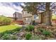 Landscaped backyard featuring a patio with outdoor seating and artificial turf at 2587 Foothills Canyon Ct, Highlands Ranch, CO 80129