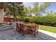 Charming backyard featuring a paved patio area, a fire pit, and lush landscaping for relaxation and entertainment at 2587 Foothills Canyon Ct, Highlands Ranch, CO 80129