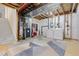 Unfinished basement with laundry area, exposed ceiling, and modern appliances, offering potential and utility at 2587 Foothills Canyon Ct, Highlands Ranch, CO 80129