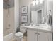 Cozy bathroom with a tub and shower and white vanity at 2587 Foothills Canyon Ct, Highlands Ranch, CO 80129