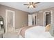 Bedroom boasts ensuite bathroom, carpeted floors, and a walk-in closet, adding convenience and storage at 2587 Foothills Canyon Ct, Highlands Ranch, CO 80129