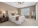 Cozy bedroom features a neutral color palette, plush carpet, and bright window with stylish shutters at 2587 Foothills Canyon Ct, Highlands Ranch, CO 80129