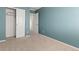 Bedroom with blue walls, neutral carpet, closet, and natural light at 2587 Foothills Canyon Ct, Highlands Ranch, CO 80129