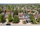 Aerial view of homes on a tree-lined street showcasing front lawns and driveways at 2587 Foothills Canyon Ct, Highlands Ranch, CO 80129