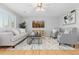 Inviting living room with natural light, neutral decor, stylish furniture, and hardwood floors at 2587 Foothills Canyon Ct, Highlands Ranch, CO 80129