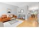 Bright living room with hardwood floors, modern decor, and dining area at 2587 Foothills Canyon Ct, Highlands Ranch, CO 80129