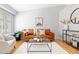 Bright living room with hardwood floors, modern decor, and bay windows at 2587 Foothills Canyon Ct, Highlands Ranch, CO 80129