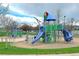 A vibrant playground offers multiple slides, climbing structures, and play areas for children in a recreational setting at 2587 Foothills Canyon Ct, Highlands Ranch, CO 80129