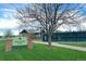 Scenic view of Redstone Park featuring a sign, walkway, and a glimpse of tennis courts surrounded by green lawns at 2587 Foothills Canyon Ct, Highlands Ranch, CO 80129