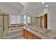 Bathroom featuring a double sink vanity, tub, and a shower with glass doors for a luxurious experience at 1743 Brookside Dr, Highlands Ranch, CO 80126