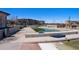 Community pool and recreation area with a building, fence, and various amenities at 16141 Bolling Dr, Denver, CO 80239