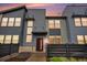 Modern townhouse with a sleek exterior, enhanced by a well-manicured front yard and inviting entryway at 16141 Bolling Dr, Denver, CO 80239