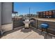 A private outdoor patio with a grill and a blue side table offers a perfect space for outdoor cooking at 16141 Bolling Dr, Denver, CO 80239