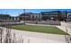 A well-maintained recreation area features artificial turf, steps and a building with multiple windows at 16141 Bolling Dr, Denver, CO 80239