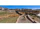 A metal bridge over a dry creek with landscaped banks connects different parts of the community at 16141 Bolling Dr, Denver, CO 80239