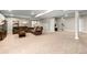 Spacious basement with neutral carpet, ample room for entertaining, and extra storage at 853 Stagecoach Dr, Lafayette, CO 80026