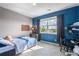 Comfortable bedroom with natural light, blue accent wall, and neutral carpet at 853 Stagecoach Dr, Lafayette, CO 80026