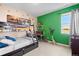 Colorful bedroom with a bunk bed, desk, and creative dinosaur-themed decor at 853 Stagecoach Dr, Lafayette, CO 80026