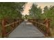 A pathway and bridge surrounded by green trees at 853 Stagecoach Dr, Lafayette, CO 80026