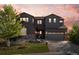 Charming two-story home with a large front yard, stone accents, and a two-car garage at 853 Stagecoach Dr, Lafayette, CO 80026