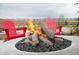 Modern fire pit with red Adirondack chairs creates a cozy outdoor gathering space at 853 Stagecoach Dr, Lafayette, CO 80026