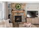 Close up of living room fireplace with stone surround, mantel, and built-in shelving at 853 Stagecoach Dr, Lafayette, CO 80026