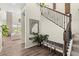 Entryway featuring hardwood floors, a staircase, decorative mirror, and a glimpse into the bright and open living area at 853 Stagecoach Dr, Lafayette, CO 80026